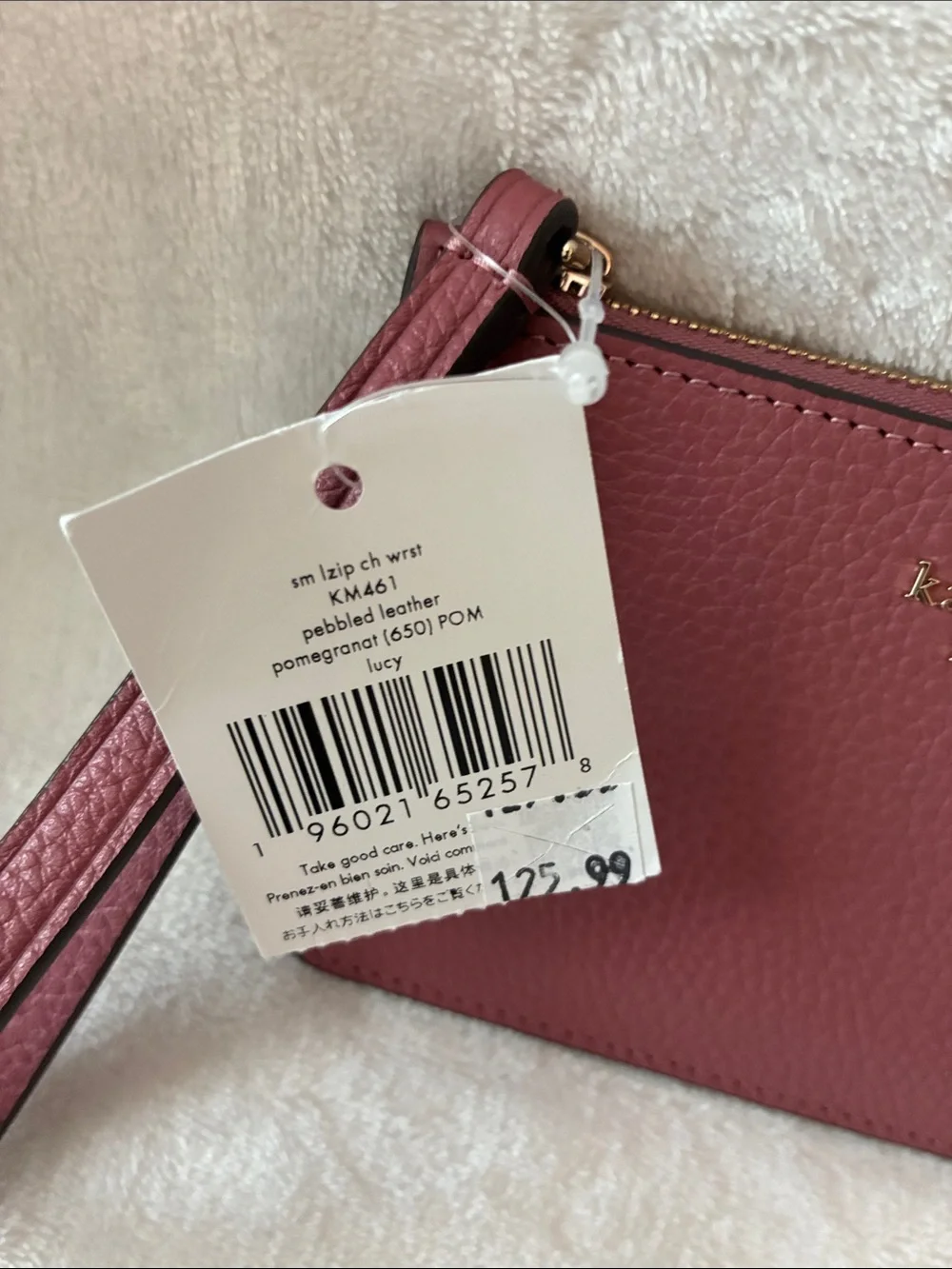kate spade pebbled leather wristlet in dusty rose with gold logo